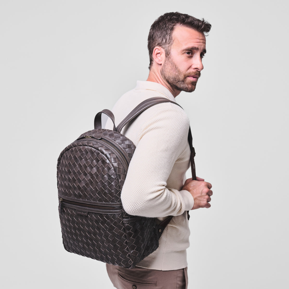 Milan woven leather backpack in Truffle Brown – worn by a model