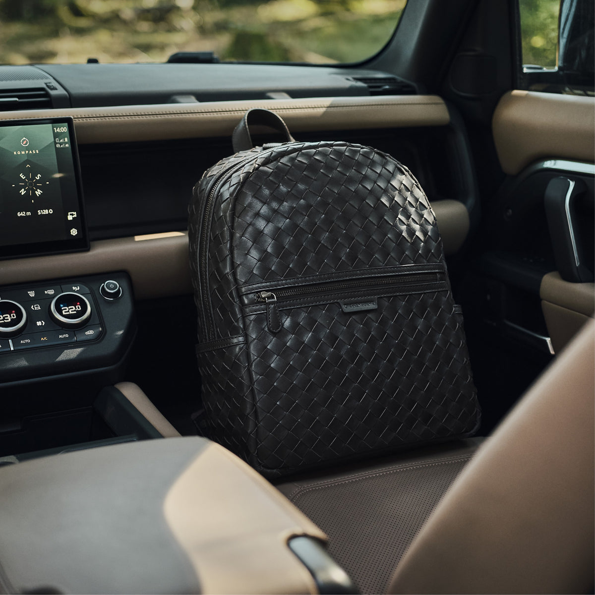 Milan woven leather backpack in Truffle Brown – in a lifestyle setting
