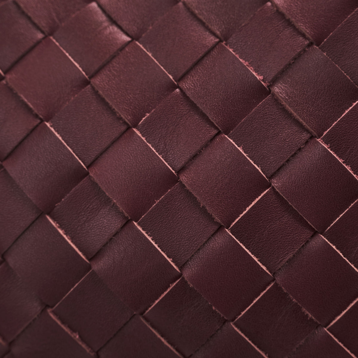 James (50) woven leather weekender in Burgundy Red with handwoven leather in close-up