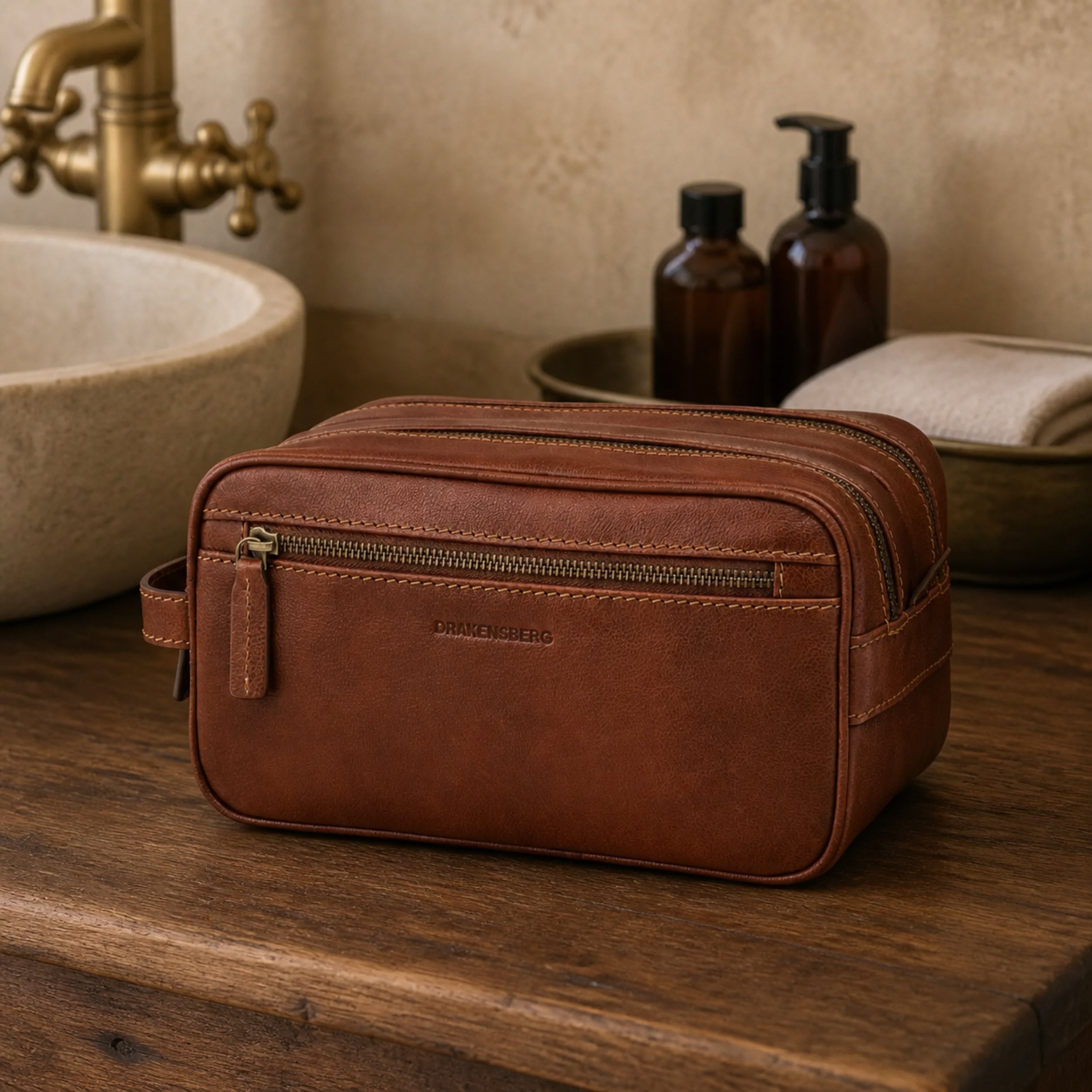 Large Enrico toiletry bag in Chestnut Brown cowhide leather in a bathroom