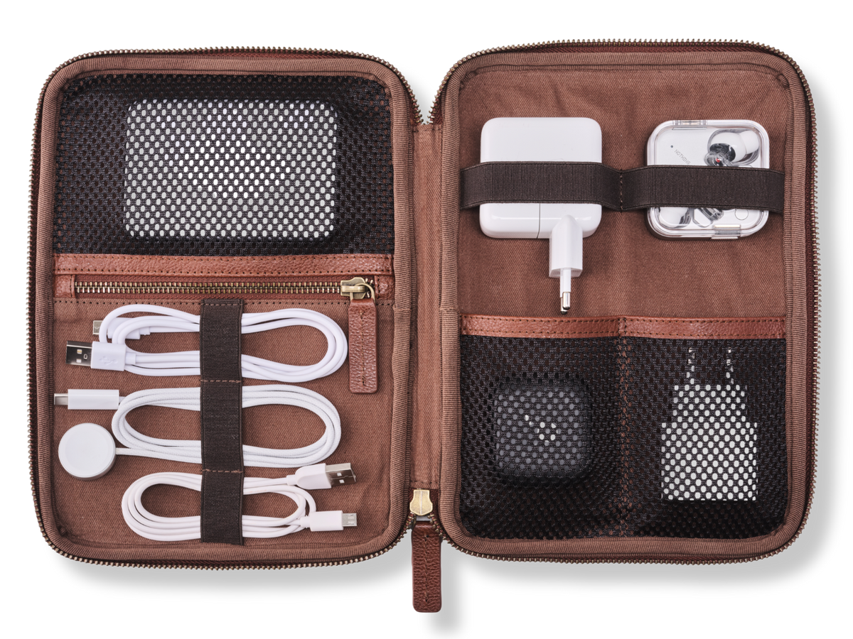 Open Porto leather cable organiser in Chestnut Brown with charging cables and tech accessories in loops and mesh pockets