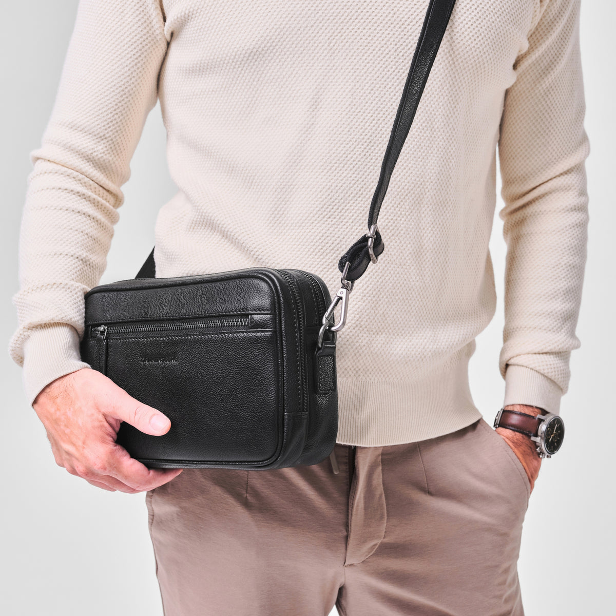 Roberto wristlet in Black carried with the wrist strap