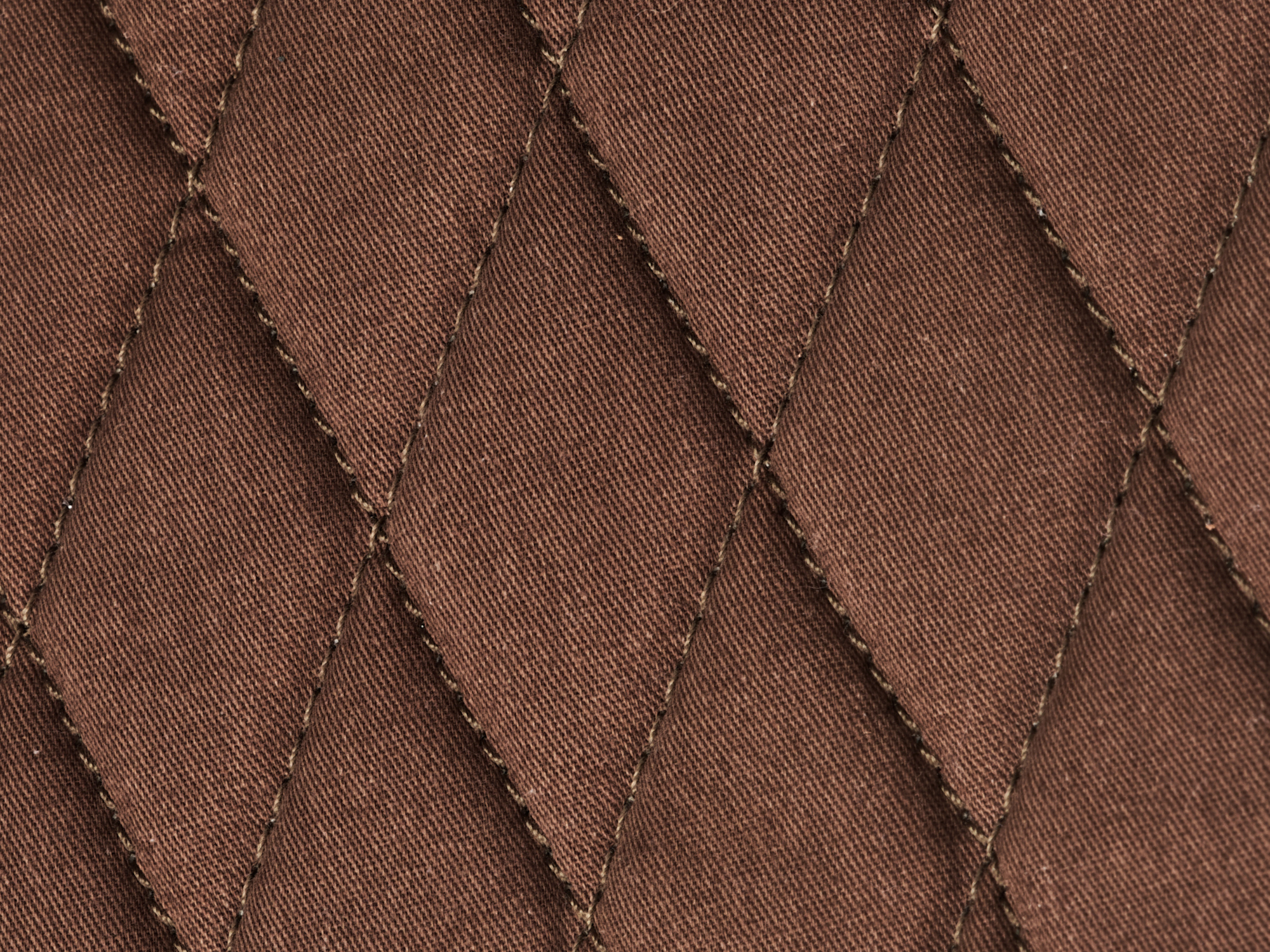 Close-up of the diamond-stitched interior padding in the Nolan buffalo leather tablet bag