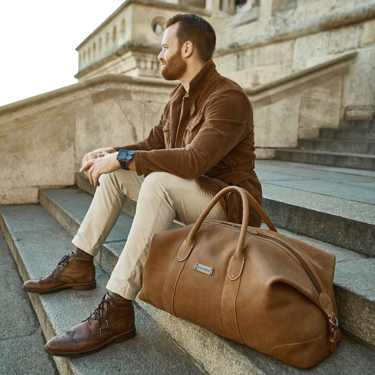 Large David leather weekender in Havana Brown – carried on steps
