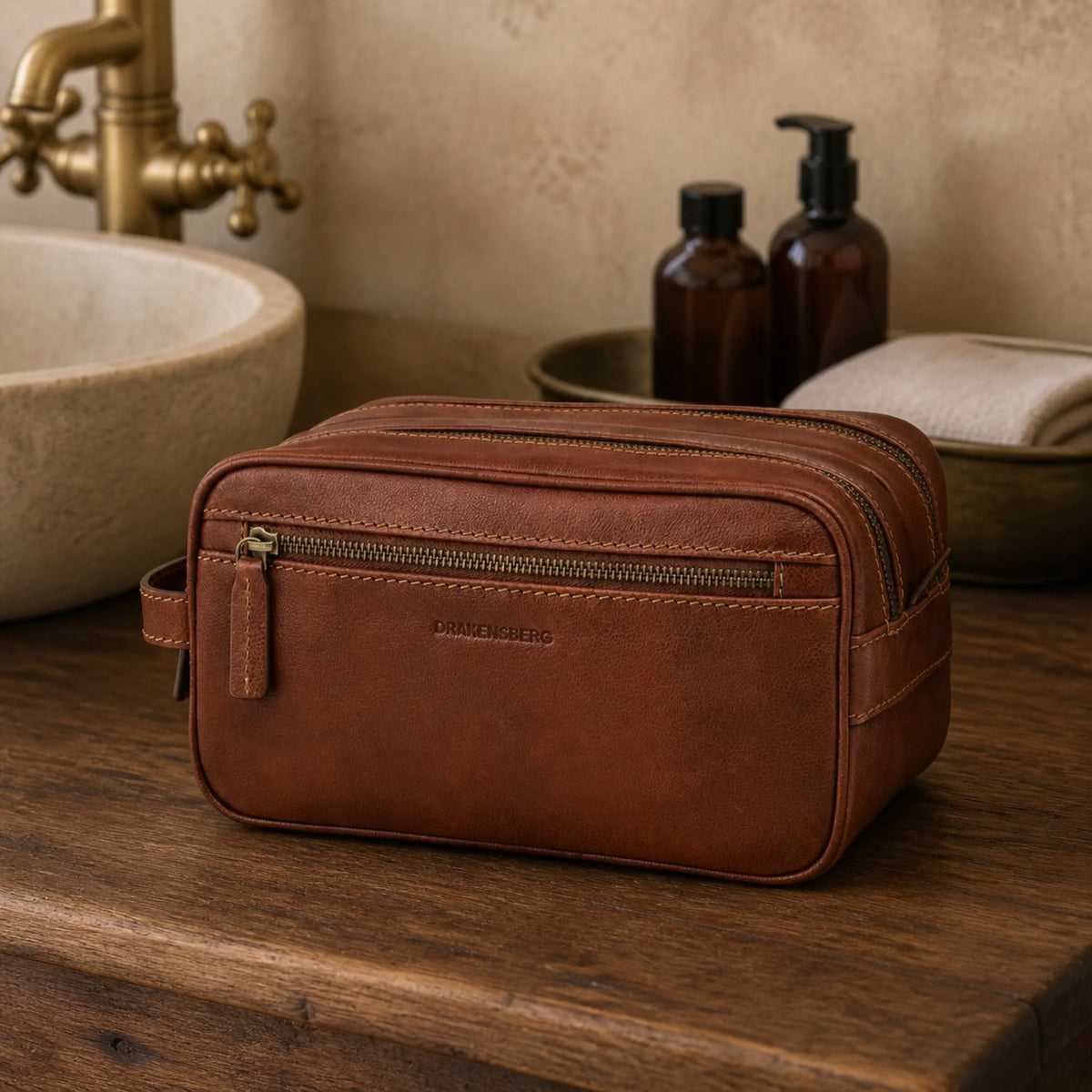 Large Enrico toiletry bag in Chestnut Brown cowhide leather in a bathroom