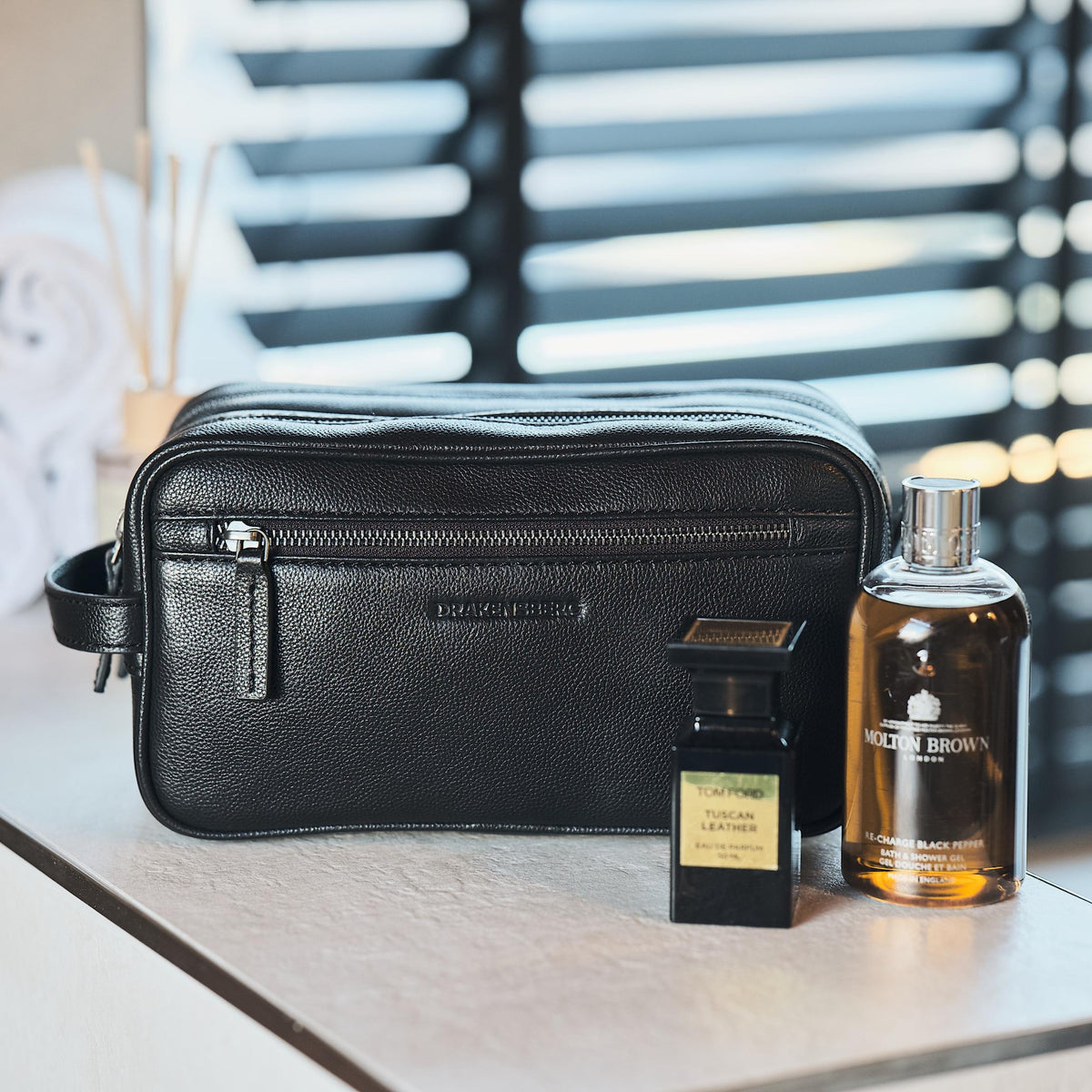 Large Enrico toiletry bag in black cowhide leather in a bathroom