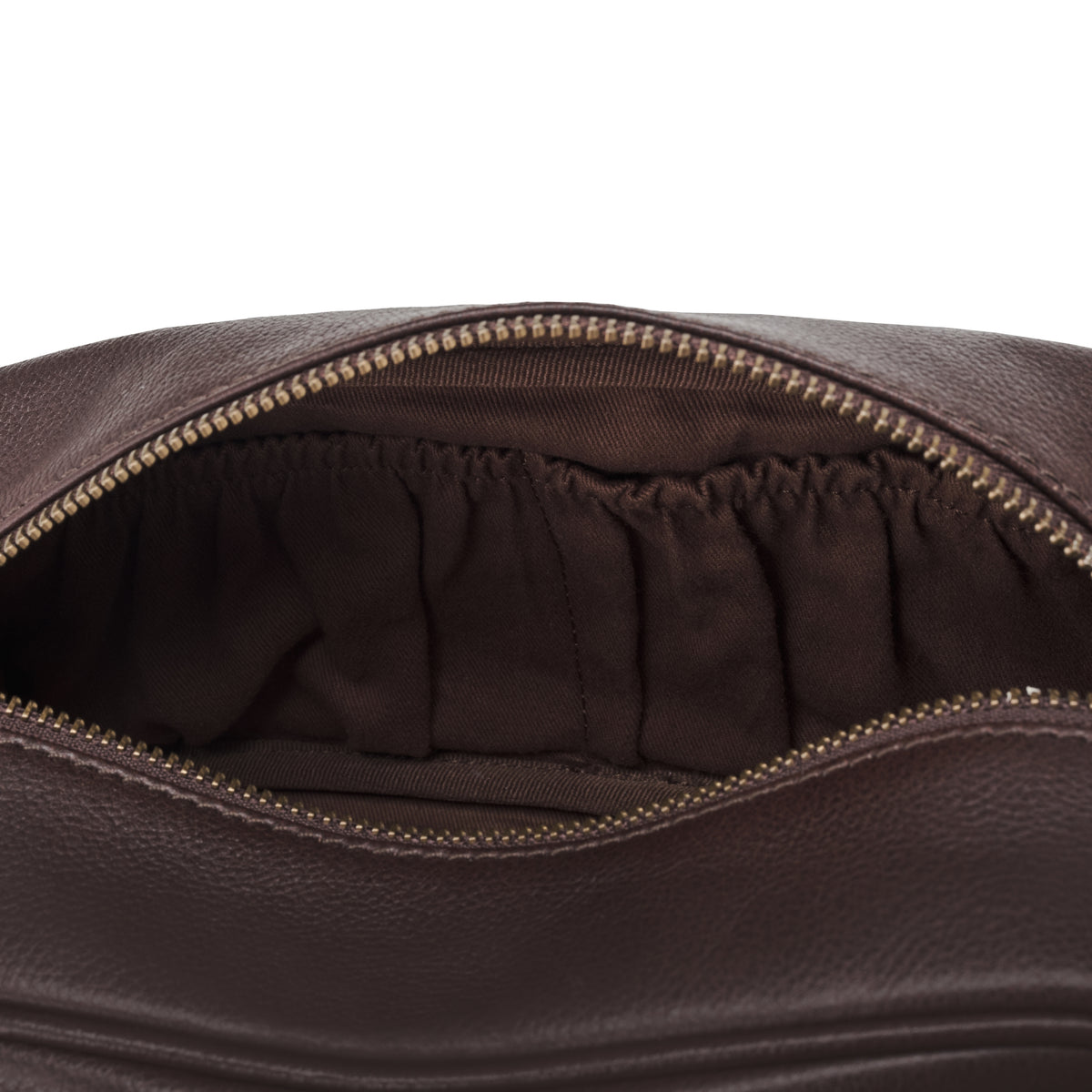 Interior view of the Dino toiletry bag in Chocolate Brown with two open pockets