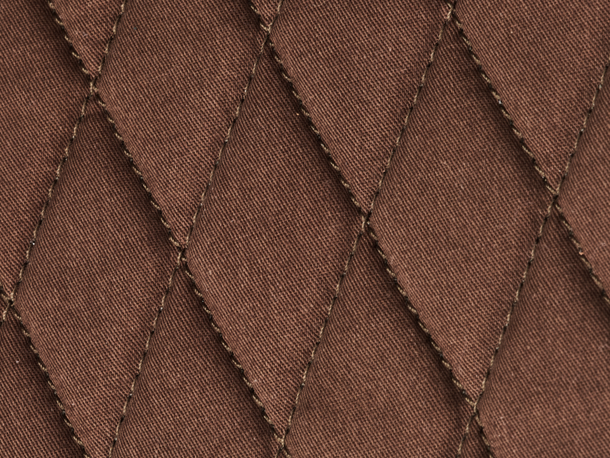 Close-up of the diamond-stitched interior padding in the Nolan buffalo leather tablet bag