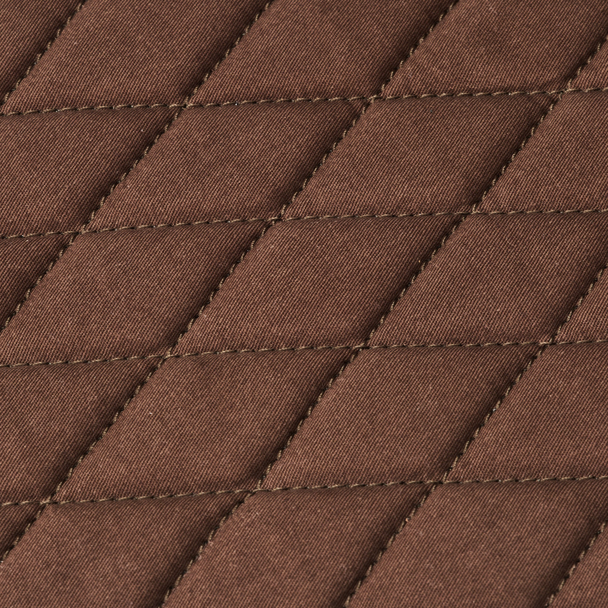 Diamond stitching on the grey-brown interior padding of the Nolan buffalo leather tablet bag